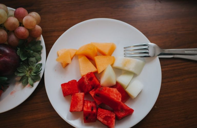 sliced watermelon and mango on plate with fork